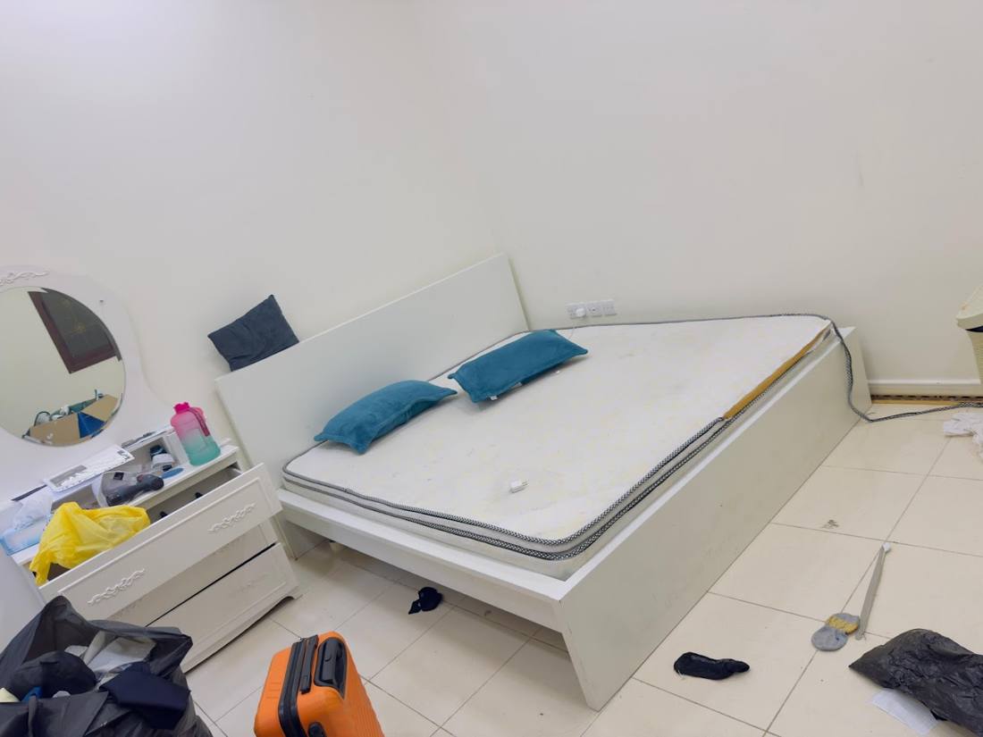 White bed being taken apart in a bedroom